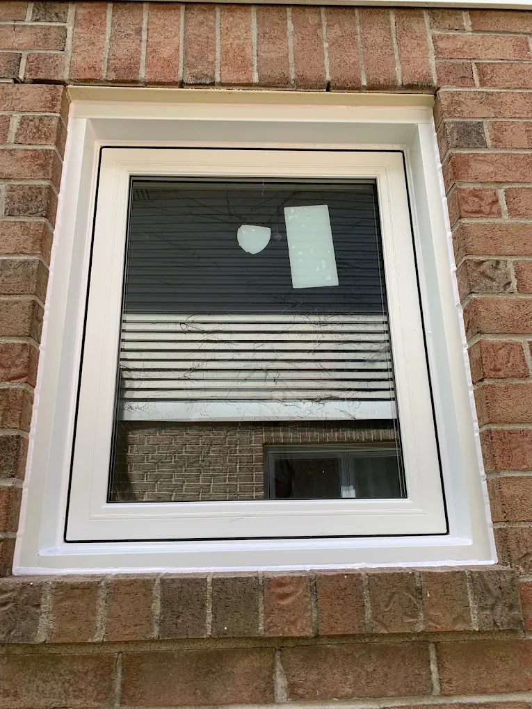 White vinyl awning window on Ottawa brick home