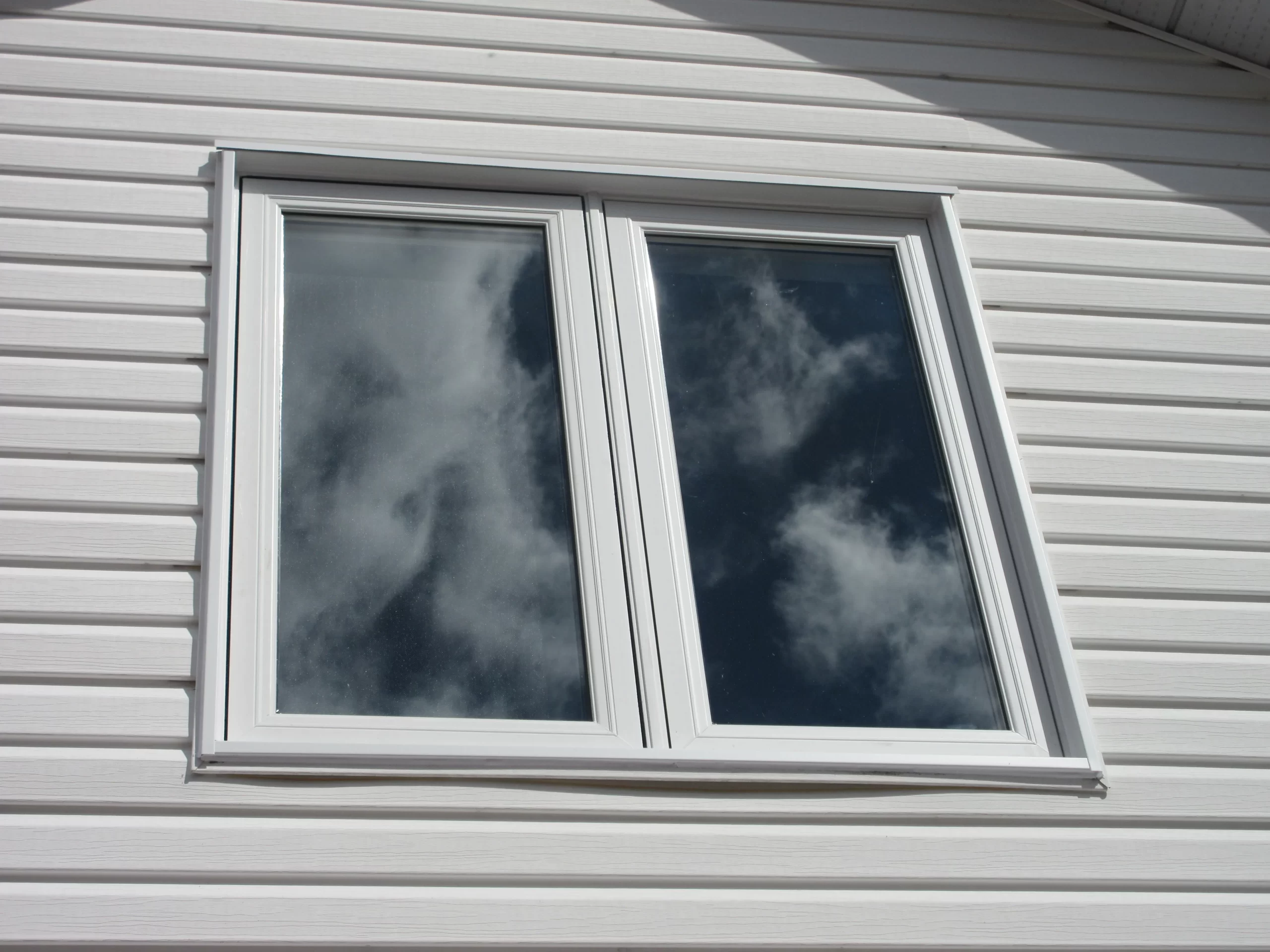Single casement window grey siding Ottawa