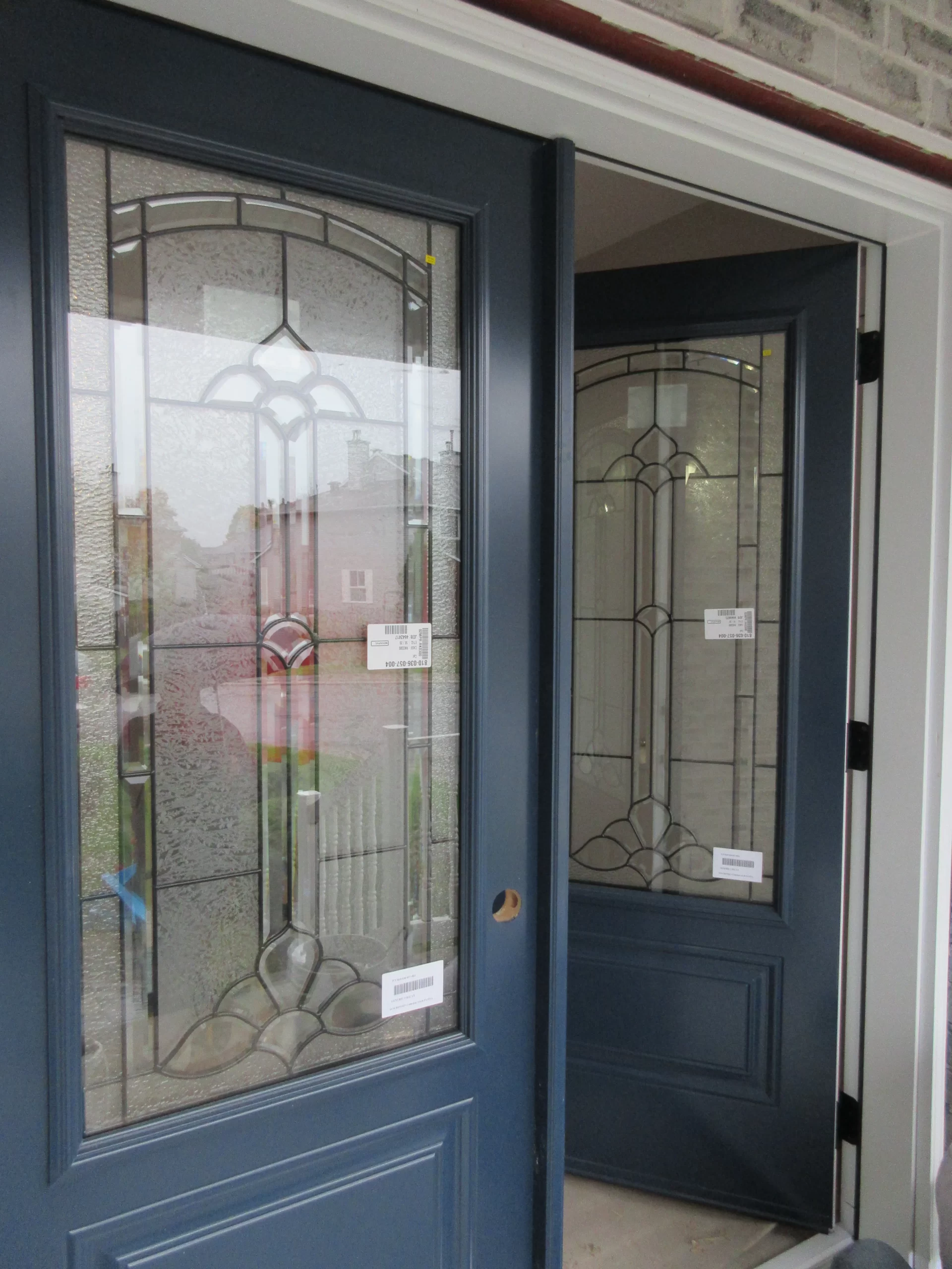 Blue double entry doors with decorative glass panels