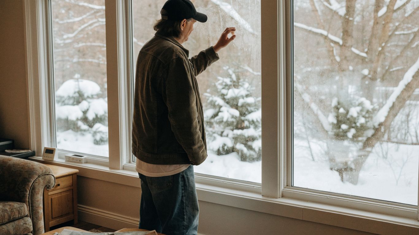 Homeowner checking winter window condensation